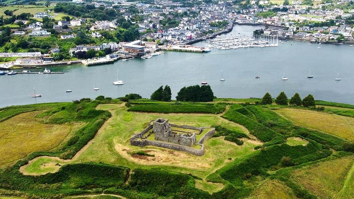 Aerial view of James Fort, Kinsale, a historic fortress surrounded by fields and situated next to a river bank.