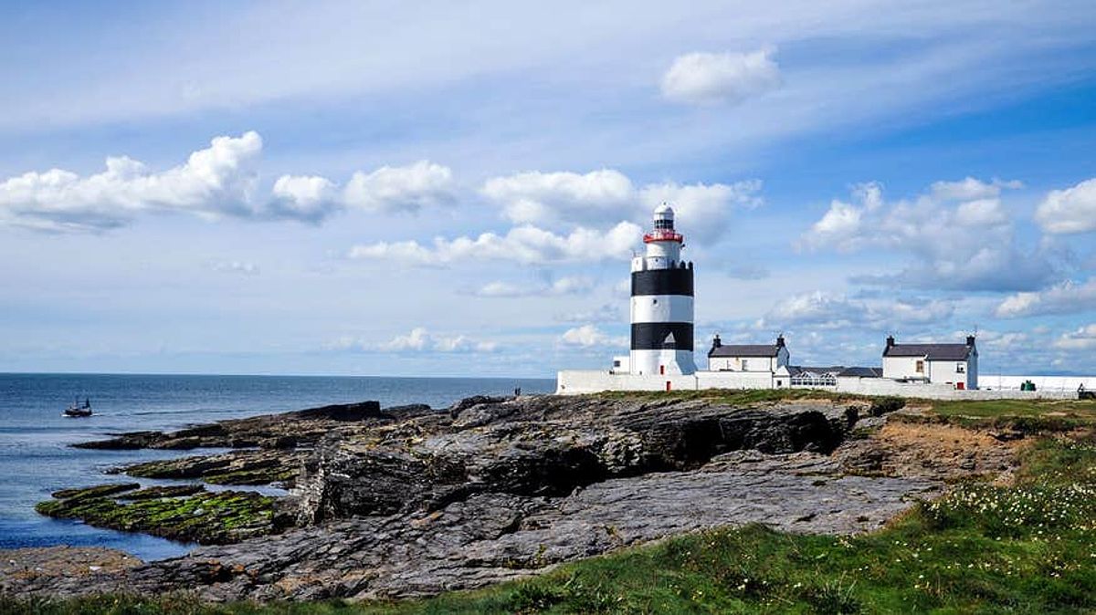 Calm waters near rocks and lighthouse on Hook Head