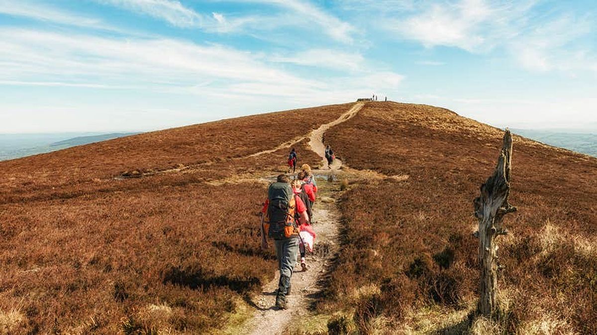 Hikers walking up a mountain in Limerick