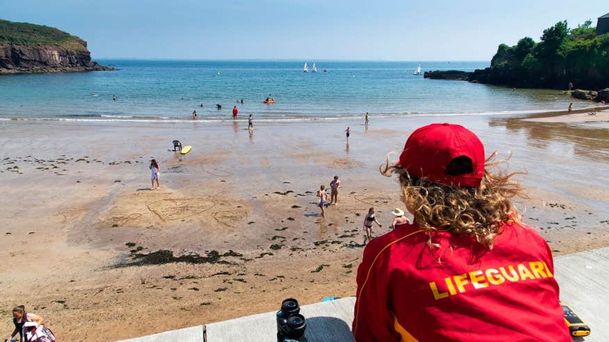 Lifeguard watching people swim at Dunmore East, Waterford