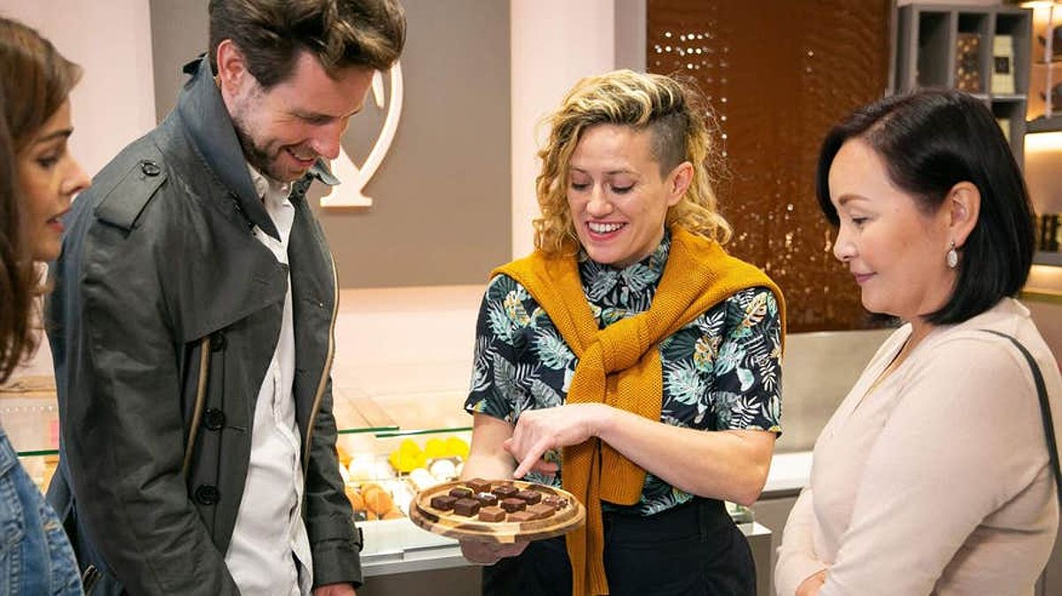 Tour guide showing a group of people different types of chocolates on a food tour in Galway