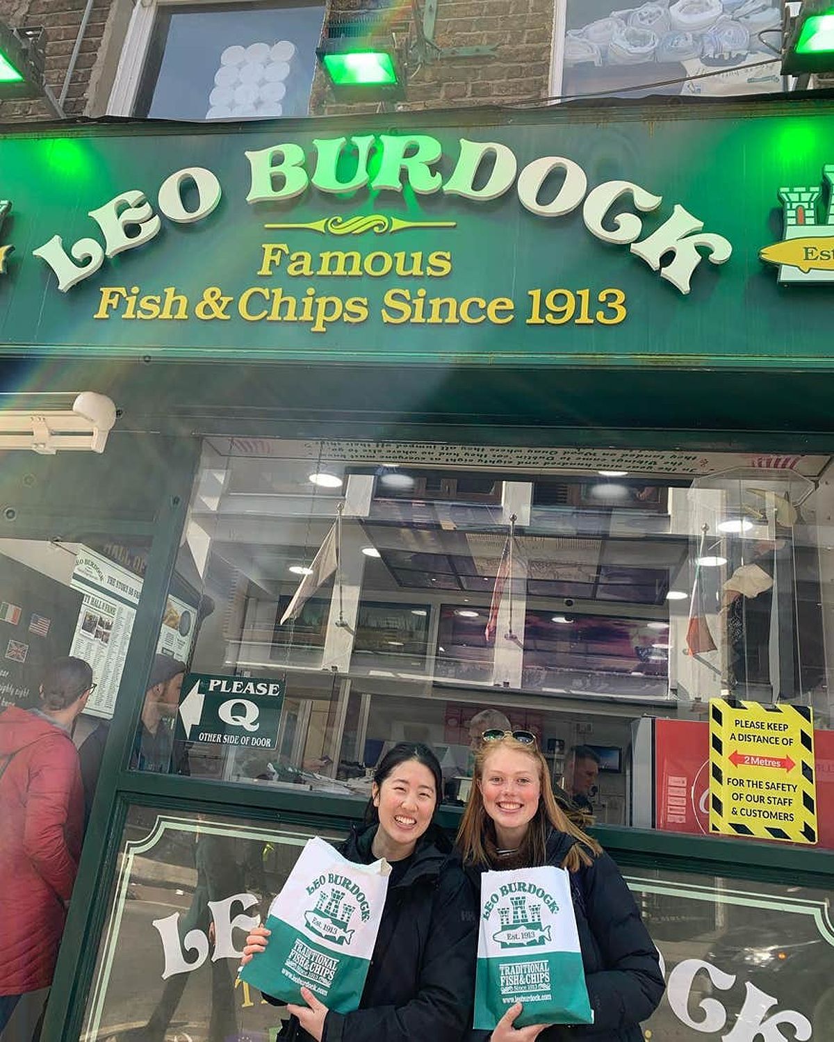 Two women standing outside Leo Burdock's fish and chip shop